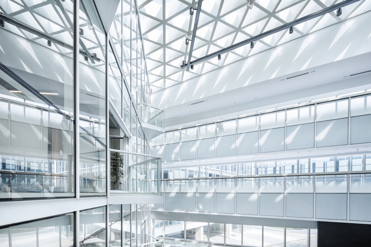 Bright, airy glass office atrium with layered walkways