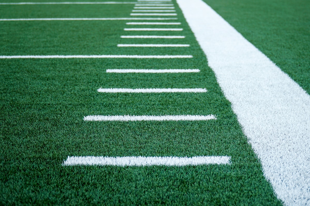 Synthetic turf sports field with white yard lines